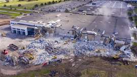 Aerial shot of excavators taking down a structure at Sessler's Leyton project site