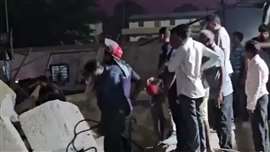 Locals assist with attempts to rescue labourers trapped after the collapse of a high-speed railway bridge in Anand district, Gujarat, India